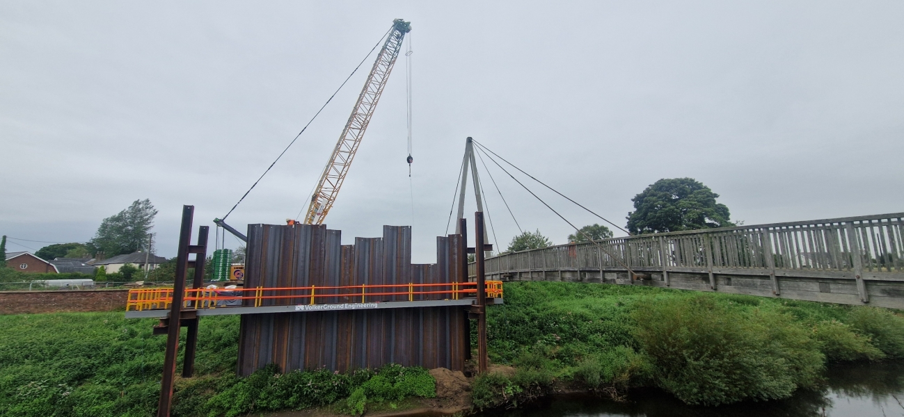 Crane lifting piles into place