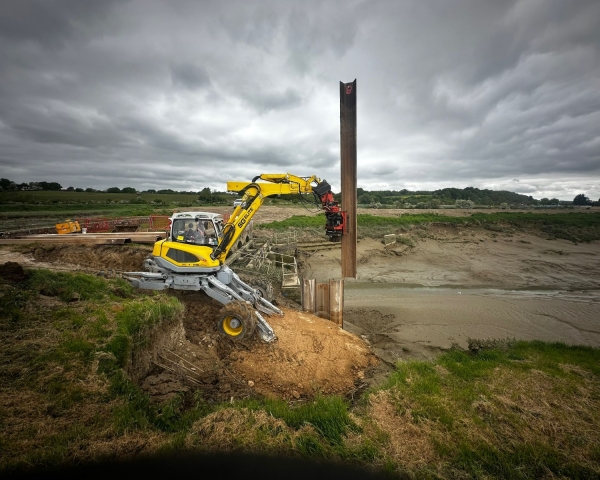 A movax driving piles into an embankment 